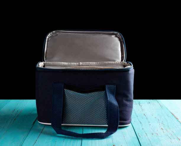 istock front view grey and blue lunch pack carrier with the top opened on a wood table on black background 1045462740