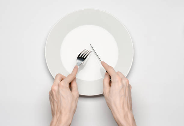 istock Restaurant and Food theme: the human hand show gesture on an empty white plate on a white background in studio isolated top view 1045462904