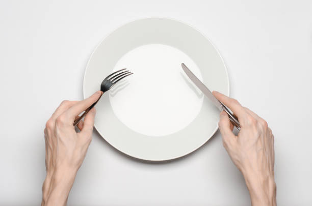istock Restaurant and Food theme: the human hand show gesture on an empty white plate on a white background in studio isolated top view 1045463034