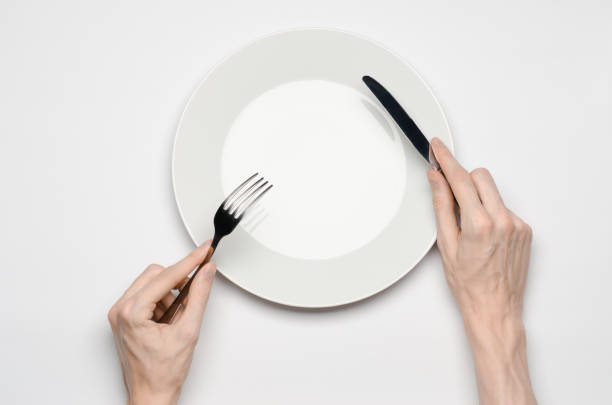 istock Restaurant and Food theme: the human hand show gesture on an empty white plate on a white background in studio isolated top view 1045463190