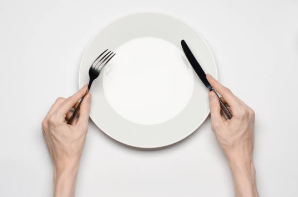 istock Restaurant and Food theme: the human hand show gesture on an empty white plate on a white background in studio isolated top view 1045465308