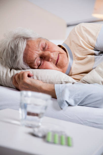 istock Pills beside a senior woman's bed 1045465386