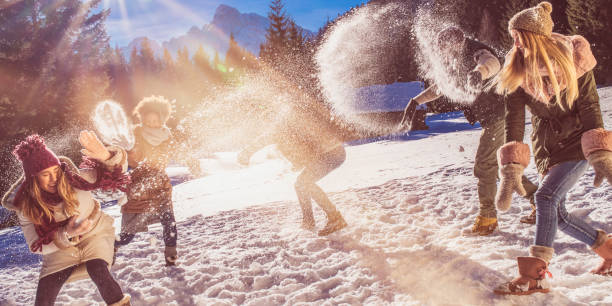 istock Young adults throwing snowballs at each other 1045465526