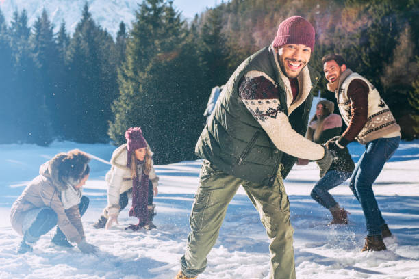 istock Smiling young adults playing in the snow 1045465532