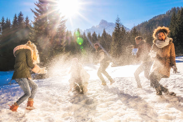istock Young adults playing in the snow, throwing snowballs 1045465546