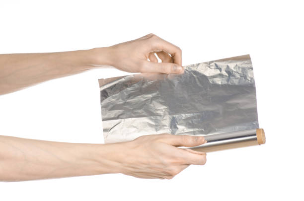 istock Cooking and shisha topic: human hand holding a foil isolated on white background in studio 1045467148