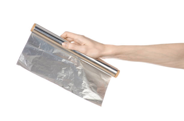 istock Cooking and shisha topic: human hand holding a foil isolated on white background in studio 1045467154