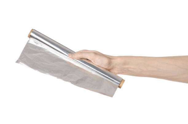 istock Cooking and shisha topic: human hand holding a foil isolated on white background in studio 1045467174