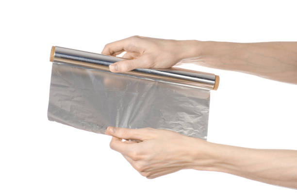 istock Cooking and shisha topic: human hand holding a foil isolated on white background in studio 1045468614
