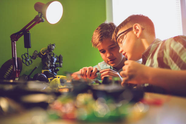 istock Small engineers working on innovative robots in their room 1045472876