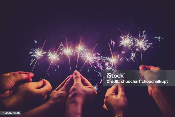 Beautiful Sparklers In People Hands On Black Backgroundholiday And Xmas And New Year Concept Stock Photo - Download Image Now