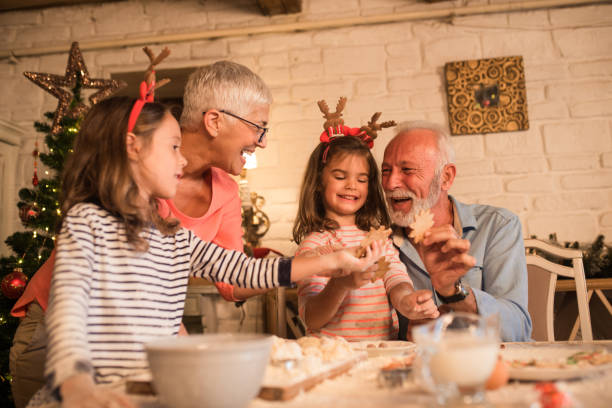 istock Smiling couple baking cookies with grandchildren 1045473632