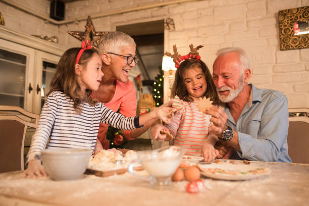istock Old couple baking cookies for grandchildren 1045473692