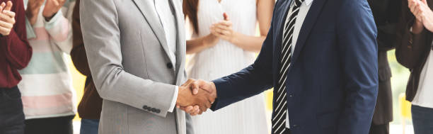 istock Cropped Image of Successful Businessmen shaking hands together. 1045473736