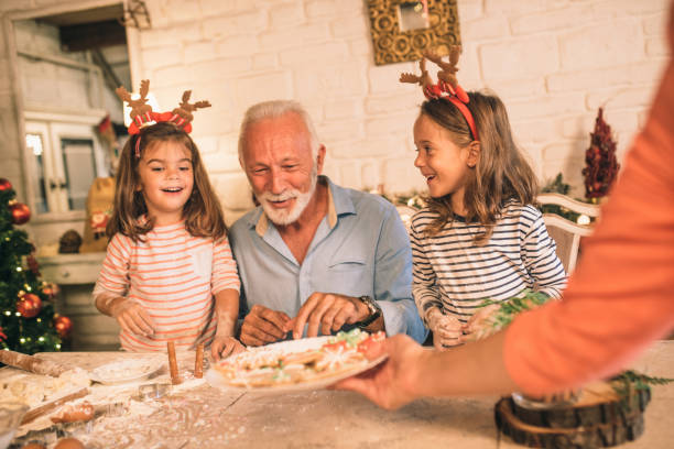 istock Grandparent and granddaughters looking at cookie plate 1045474088