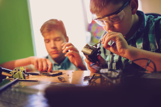 istock Small engineers working on innovative robots in their room 1045474106