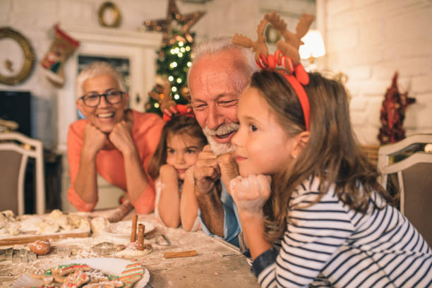 istock Old man with his wife and granddaughters 1045476350