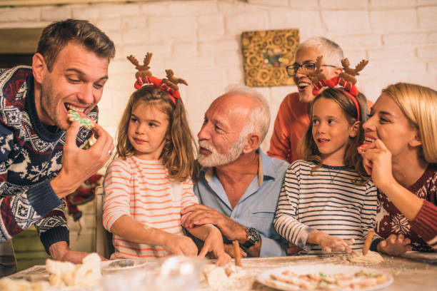 istock Family looking at young man eating a cookie 1045476804