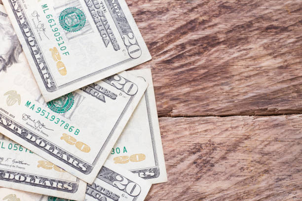 istock twenty dollar bills on wood 1045483070
