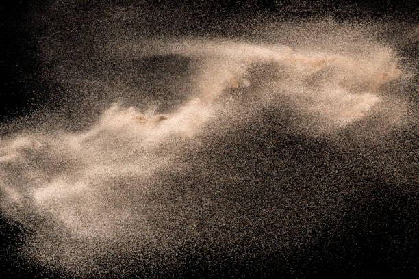 istock Dry river sand explosion. Golden colored sand splash agianst dark background. 1045483434