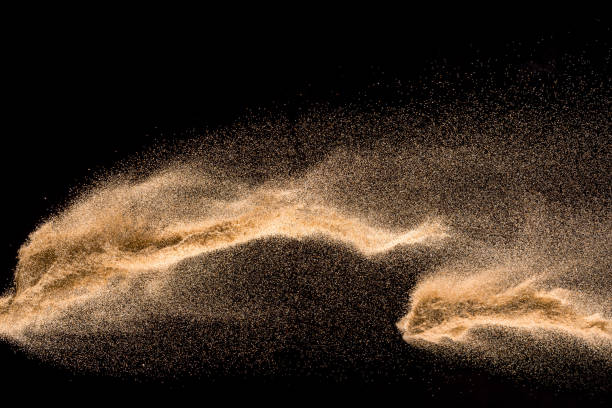 istock Dry river sand explosion. Golden colored sand splash agianst dark background. 1045483466