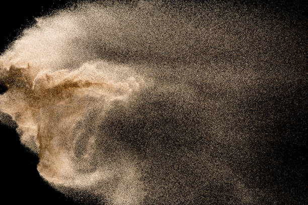 istock Dry river sand explosion. Golden colored sand splash agianst dark background. 1045483488