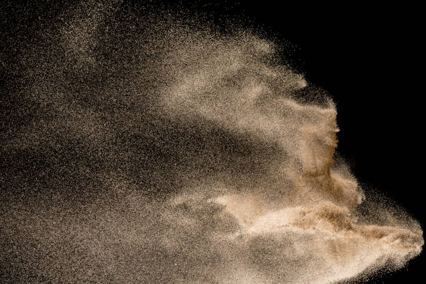 istock Dry river sand explosion. Golden colored sand splash agianst dark background. 1045483504