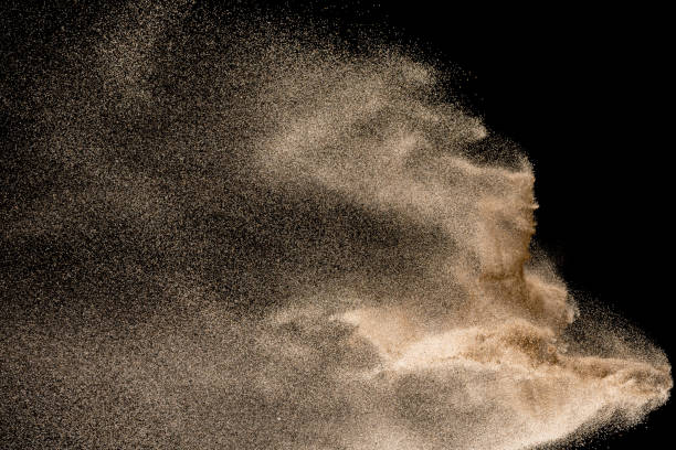 Dry river sand explosion. Golden colored sand splash agianst dark background. Dry river sand explosion. Golden colored sand splash agianst dark background. dust storm stock pictures, royalty-free photos & images