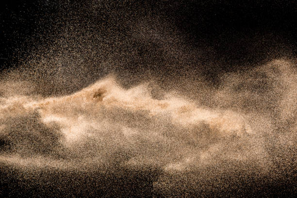 istock Dry river sand explosion. Golden colored sand splash agianst dark background. 1045483512