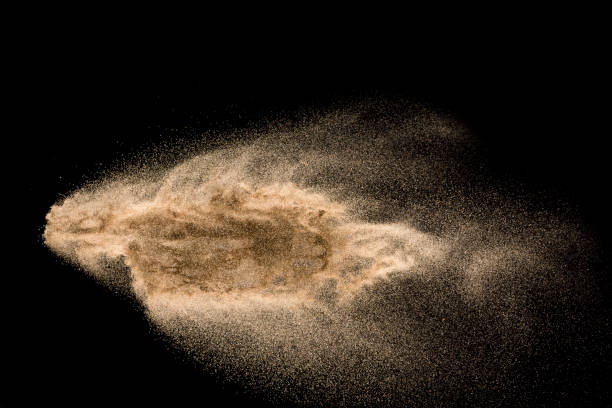 istock Dry river sand explosion. Golden colored sand splash agianst dark background. 1045483516