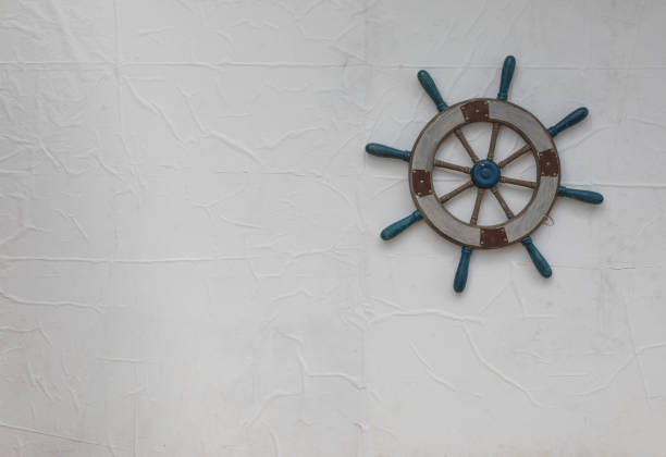 istock Vintage wooden ship's wheel on white background 1045492336