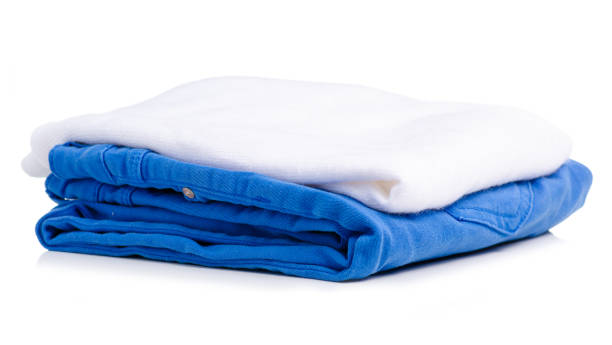 istock Stack of clothing blue jeans and white sweater 1045495184