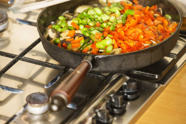 Dieting eating, preparing food concept. Many chopped healthy vegetables on frying pan, food p