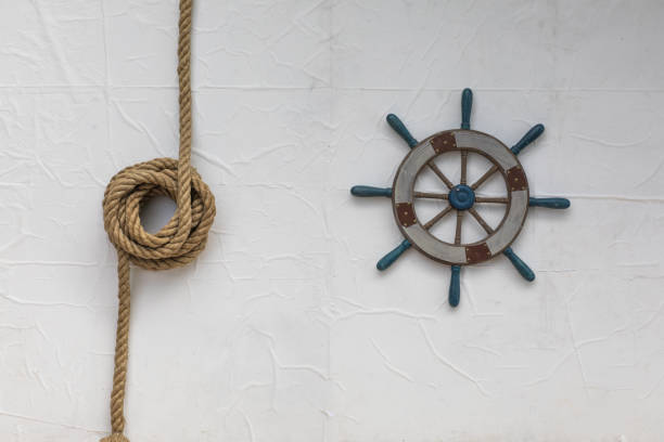 istock Vintage wooden ship's wheel on white background 1045499962