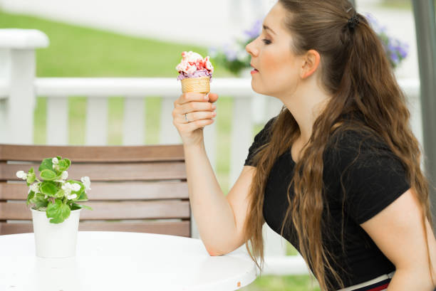 istock Young woman eating ice cream 1045500444