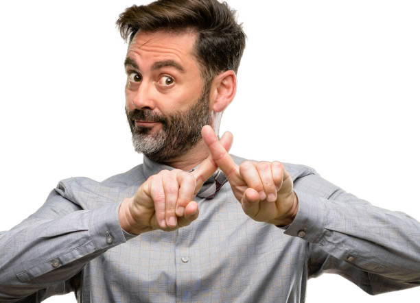 istock Middle age man, with beard and bow tie annoyed with bad attitude making stop sign with hand, saying no, expressing security, defense or restriction, maybe pushing 1045500488