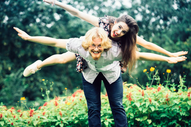 istock Happy couple playing in park 1045501792