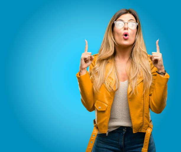 istock happy and surprised cheering expressing wow gesture pointing up 1045503960