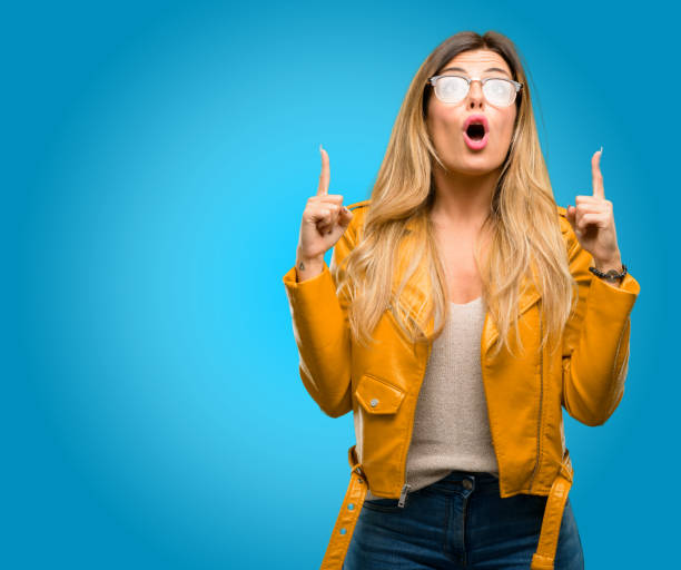 istock happy and surprised cheering expressing wow gesture pointing up 1045503970