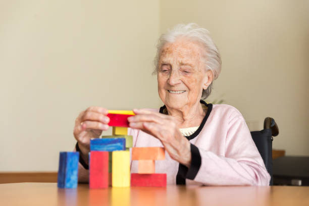 istock Senior woman with wooden blocks 1045504182