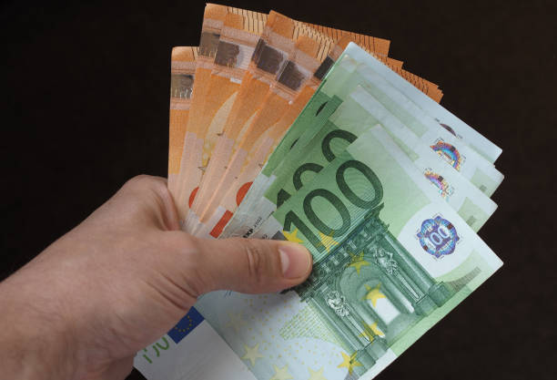 istock Hand with Euro notes, European Union 1045504608