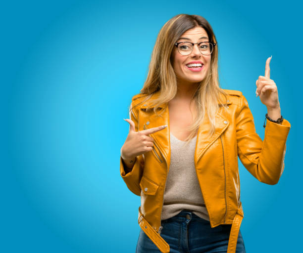 istock happy and surprised cheering expressing wow gesture pointing up 1045505464