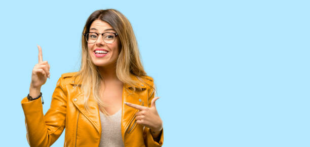 istock happy and surprised cheering expressing wow gesture pointing up 1045505482