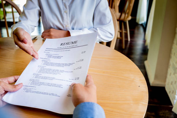 istock Woman submits job application, Interviewer reading a resume. 1045506762