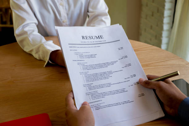 istock Woman submits job application, Interviewer reading a resume. 1045510322