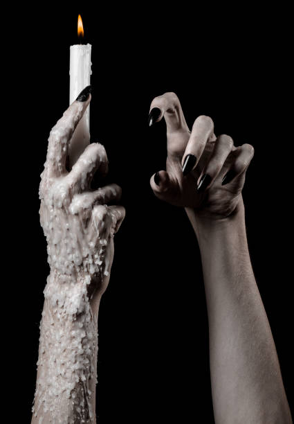 istock hands holding a candle, a candle is lit, black background, solitude, warmth, in the dark, Hands death, hands witch 1045510402