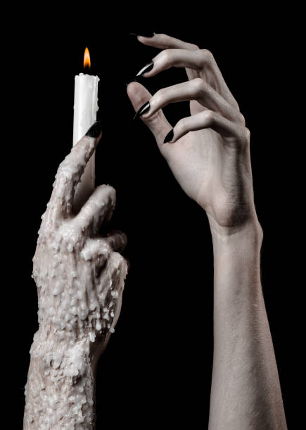 istock hands holding a candle, a candle is lit, black background, solitude, warmth, in the dark, Hands death, hands witch 1045510422