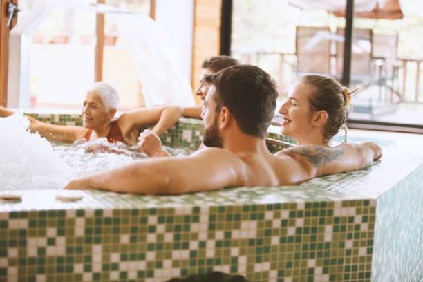 istock People relaxing in a hot tub 1045515416