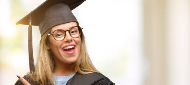 istock Young woman university graduate student pointing away side with finger 1045520784