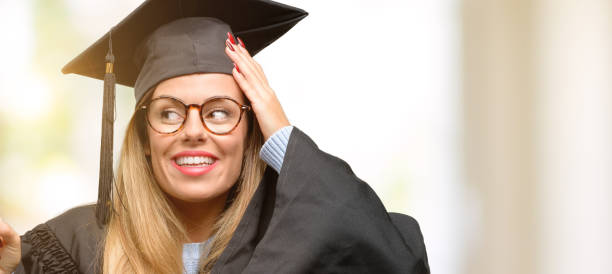 istock Young woman university graduate student pointing away side with finger 1045522934